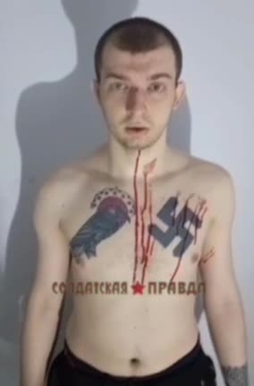A captive Ukrainian neo-Nazi in all his tattooed glory.