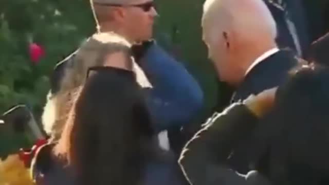 President Biden strokes little girl