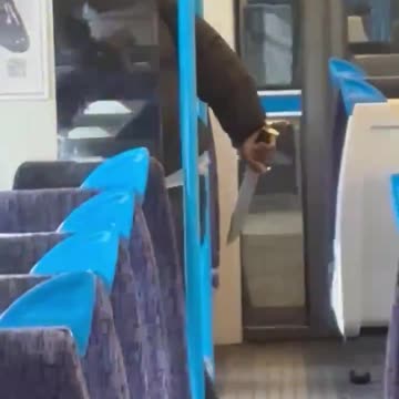 A man with a knife attacking a person on the train in the UK near Victoria station