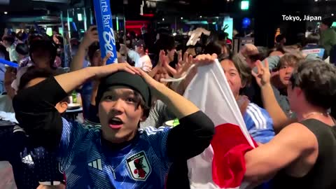 Japan fans celebrate after stunning win over Spain