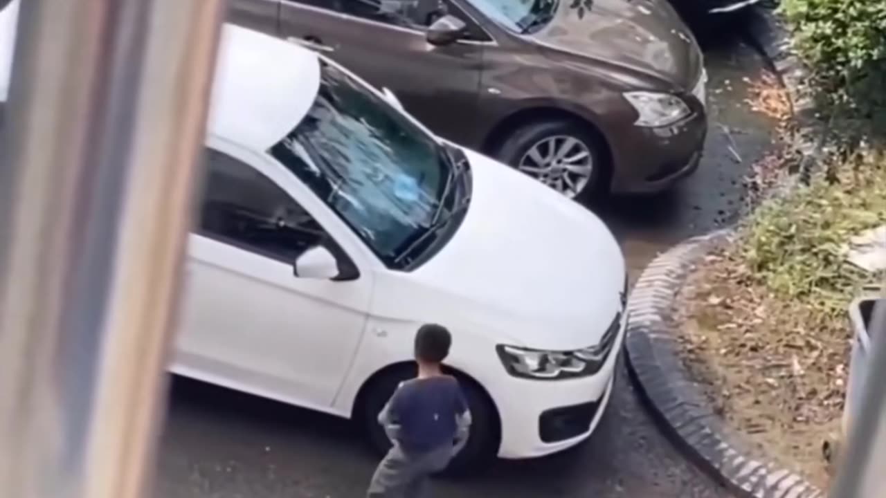 Young boy mistakenly splashed muddy water on car then responsibly clean it.