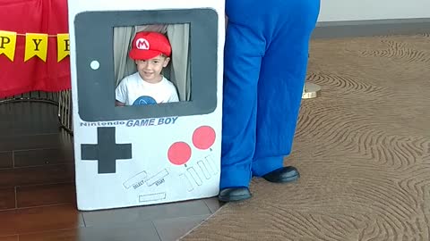 Houston mascot party character Mario poses for pictures at the Gameboy photo prop at a birthday