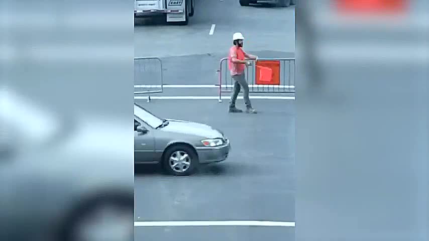 Construction Worker Dances on Road While Directing Traffic