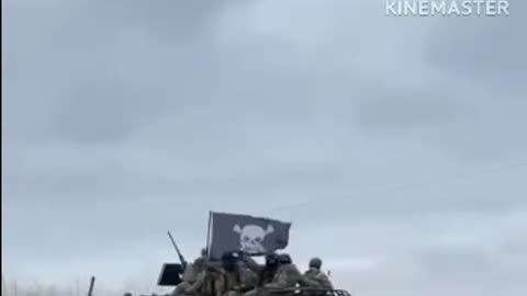 Ukrainian fighters riding on armor with Nazi crosses.