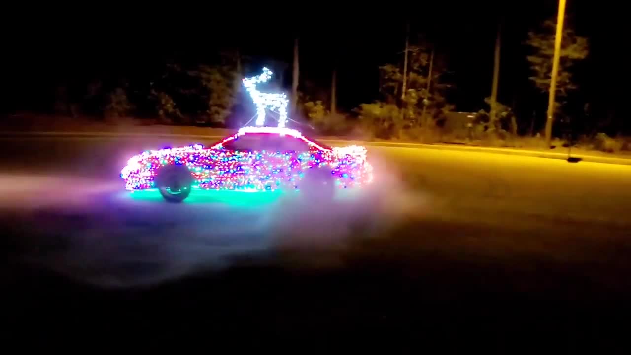 Race Car Decorated With LED Lights for Christmas Does Donuts on Street