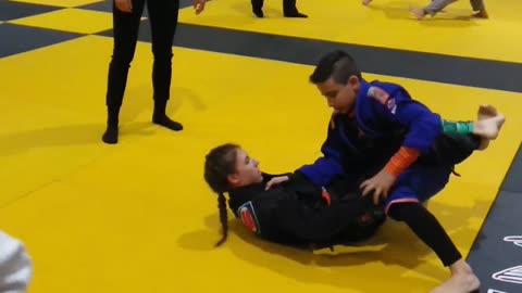 Young lady schools a boy in the art of the armbar Jiu Jitsu!!!