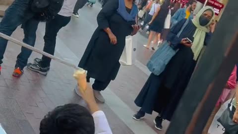 My little brother under Burj khalifa getting Turkish ice cream