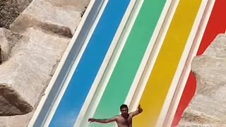 Man Descends Waterslide in Style