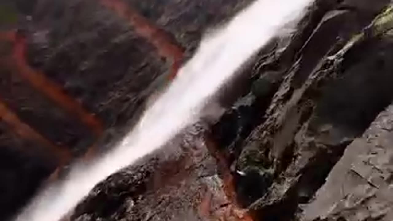 passing between the waterfall