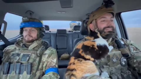 Ukrainian soldiers with a furry companion on the way to perform combat