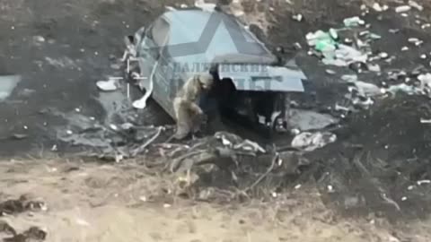 Ukrainian soldier tries to hide inside a car.