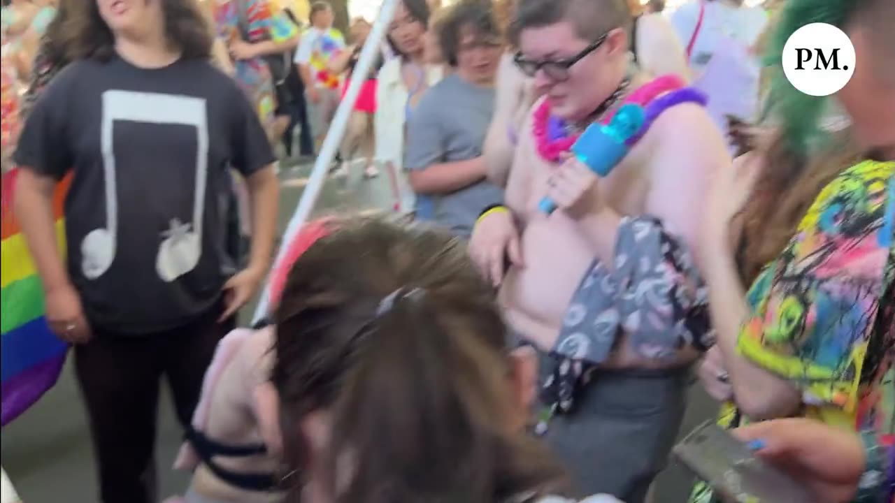 PRIDE Supporters surround a street preacher and bark like rabid dogs