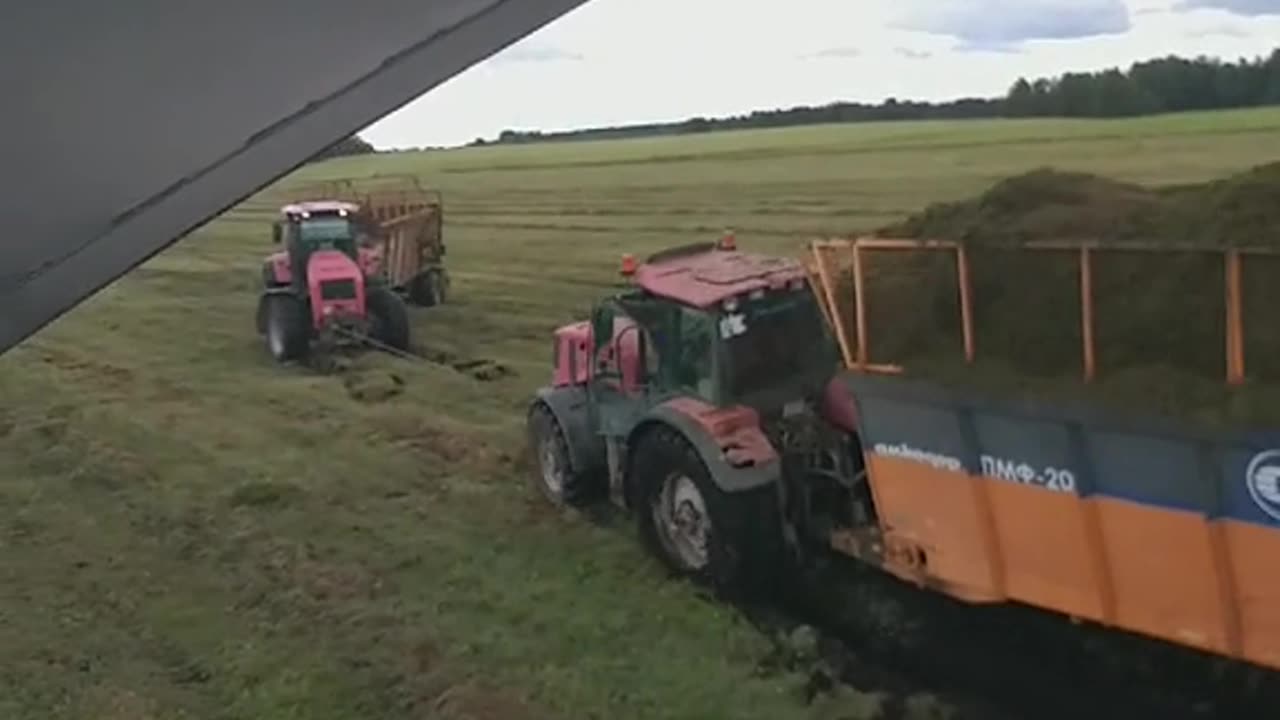 A trailer with grass overturned on the field