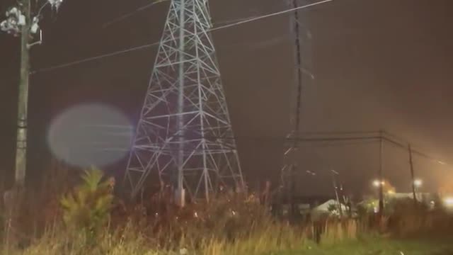 Emergency crews work to rescue two people from plane stuck in power lines