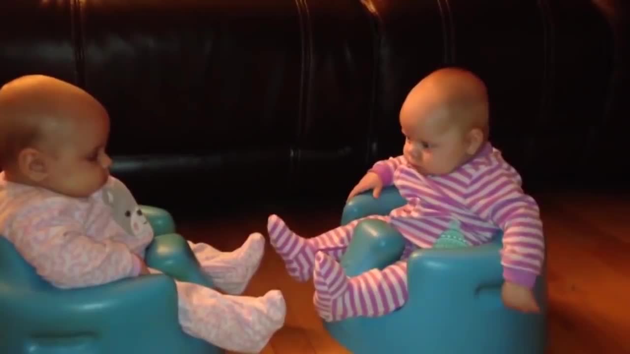 Twin baby playing
