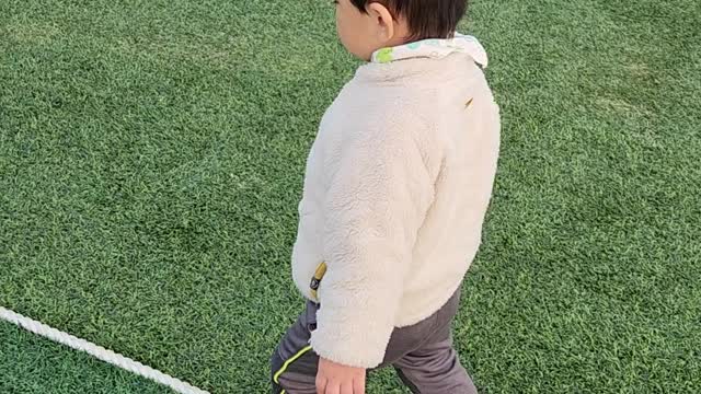 A baby playing in the playground