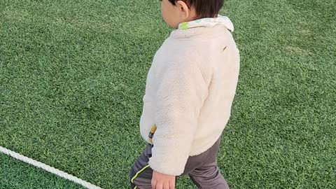 A baby playing in the playground