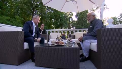 Russian President Putin and Indian Prime Minister Narendra Modi hug each other.