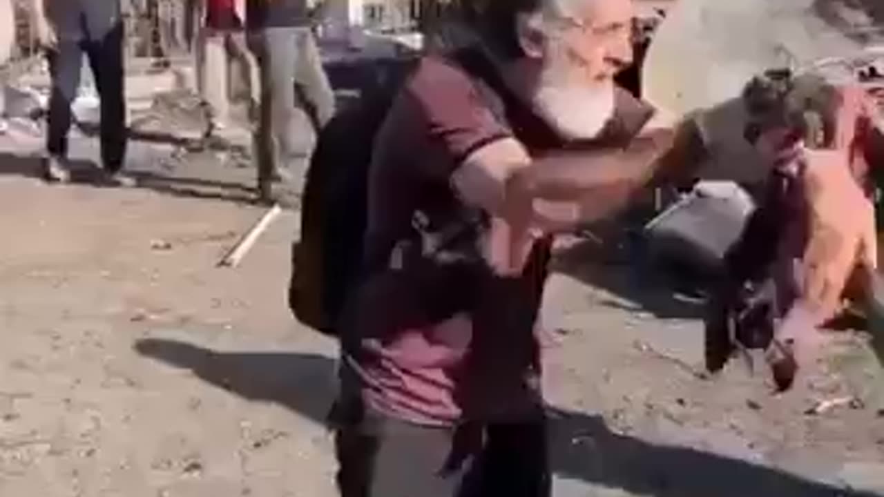 A Palestinian father show what is remaining of his toddler killed by an Isreali airstrike.