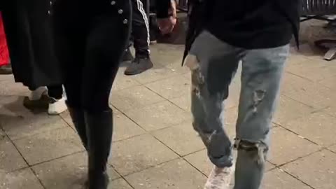 A handsome man asks a beautiful woman to dance