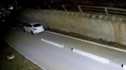 Wall collapses on parked car