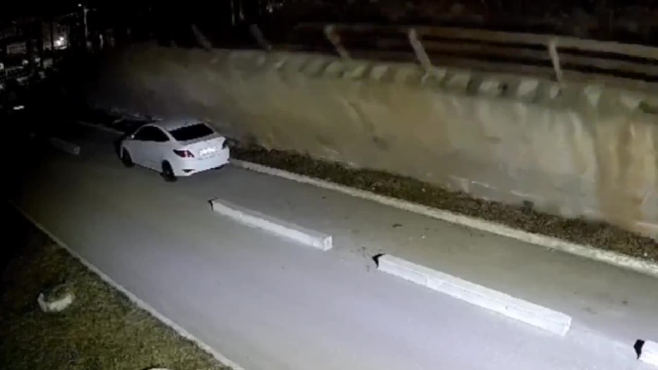 Wall collapses on parked car