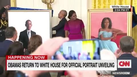 Barack Obama gives a speech after the unveiling of his White House portrait