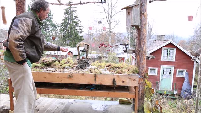 Photographer with Squirrels with the wishing well