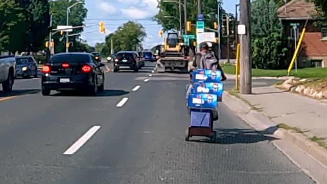 This cyclist takes his summer refreshments very seriously