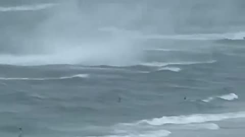 Footage captures waterspout ripping through crowded beach #Shorts