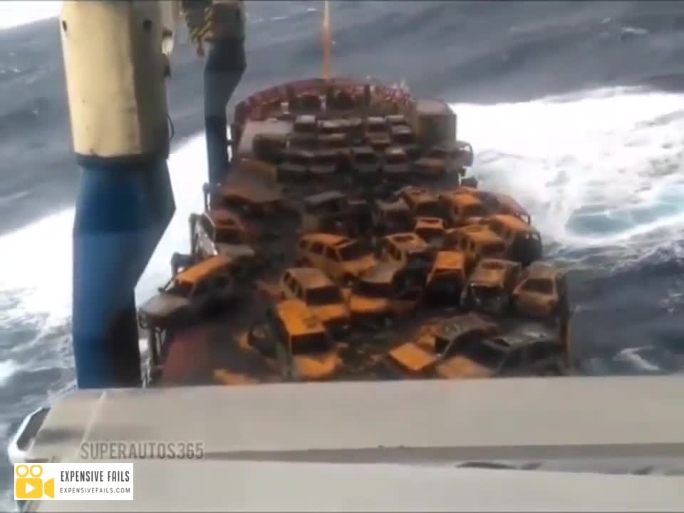 Cars getting transported on a ships open deck catch on fire