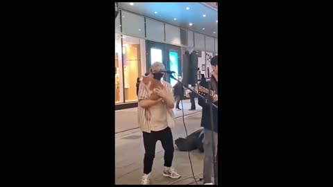 cat singing karaoke in the streets of china