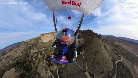 Daredevil wingsuit pilot flies under Puento Nuevo arch in Ronda, Spain