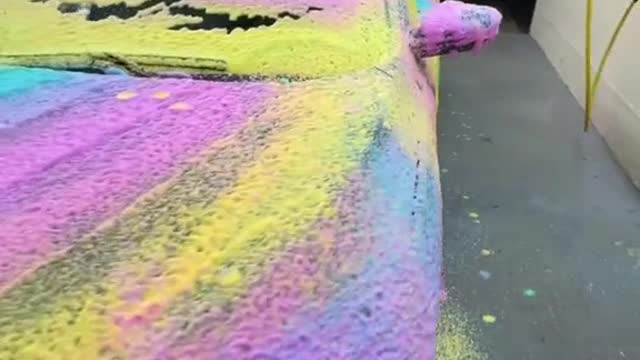 Before washing the car, spray colored foam.