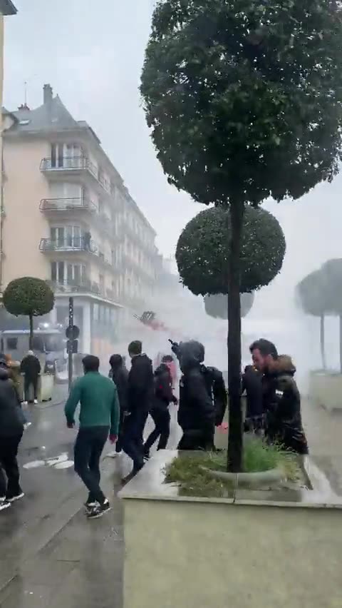 French protesters use a tractor to fight off water cannon in Rennes.