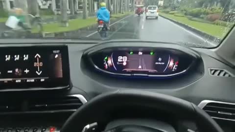 driving a car while enjoying the rain