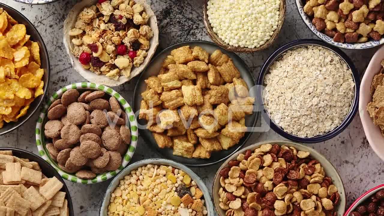 Assortment of different kinds cereals placed in ceramic bowls on table-Assortment of different kinds