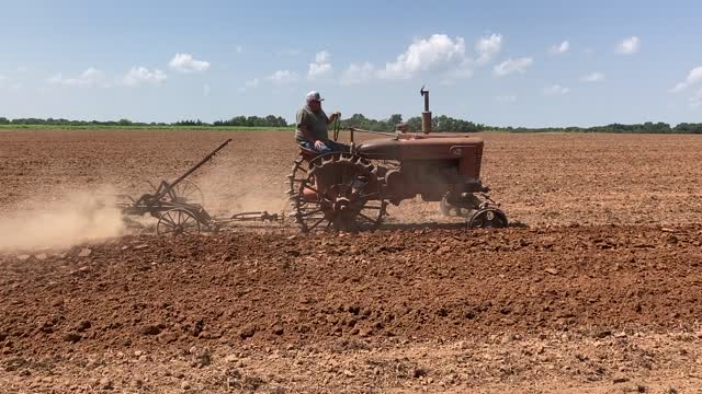 Farmall H on steel wheels plowing.