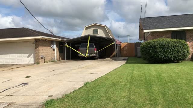 Truck Tied to Car Canopy in Preparation for Hurricane Ida