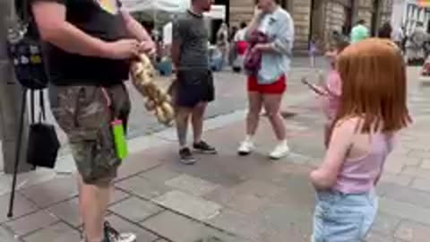 The Balloon Guy makes a wee customer happy. Can you guess what it