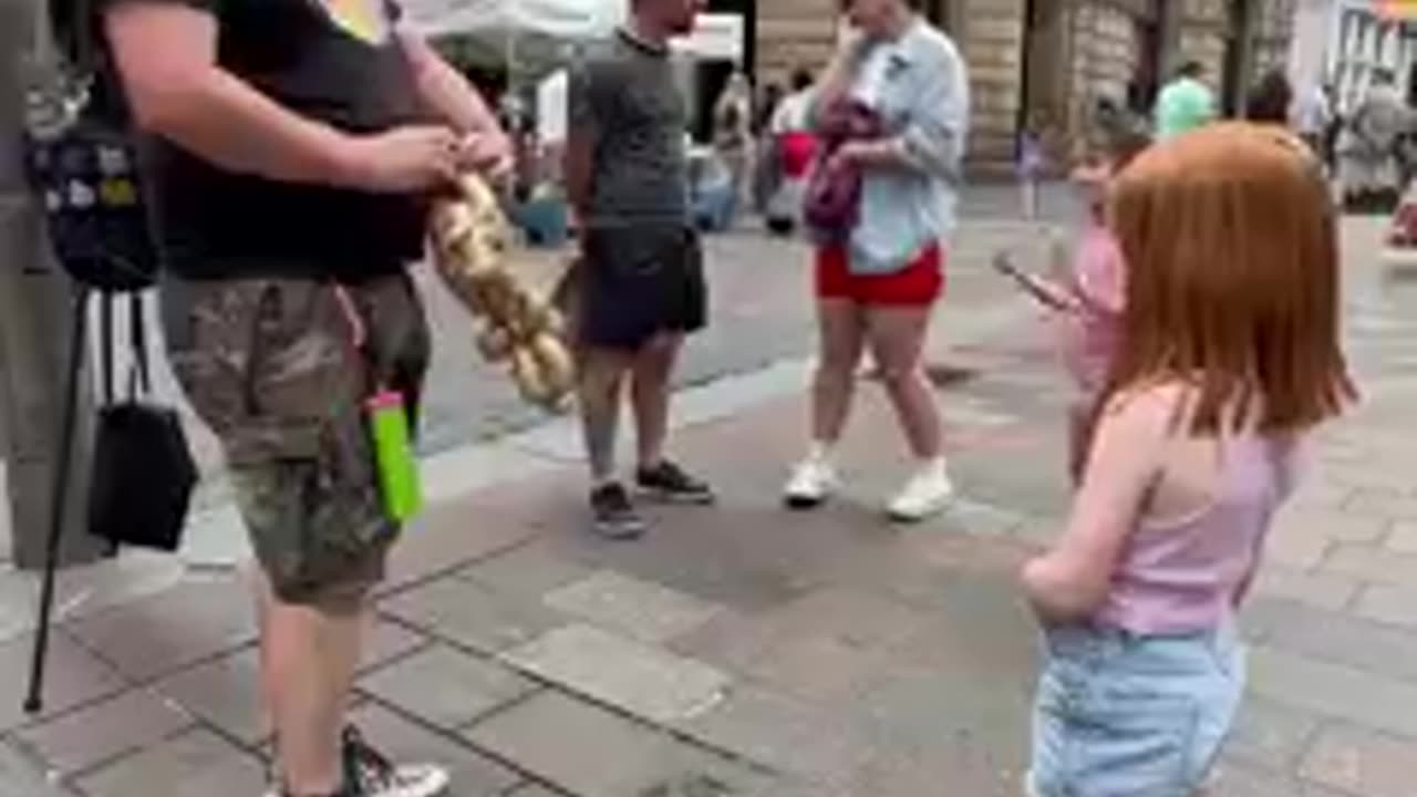 The Balloon Guy makes a wee customer happy. Can you guess what it