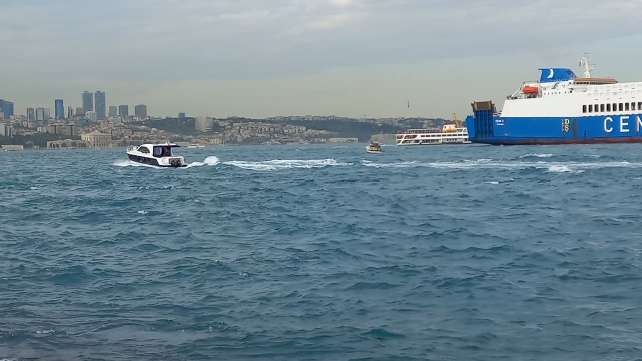 The white ship running in the sea, with ships and the beautiful sea behind it