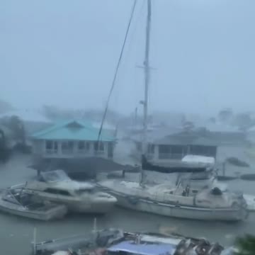Hurricane Ian doing unreal damage to Florida, yachts floating by.