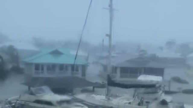 Hurricane Ian doing unreal damage to Florida, yachts floating by.