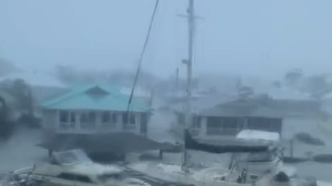 Hurricane Ian doing unreal damage to Florida, yachts floating by.