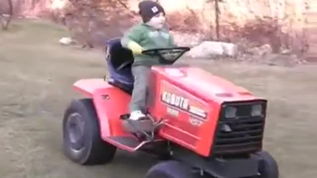 MM #2 - 2009 Daniel driving the Kubota G6200H around the yard.