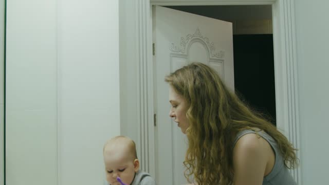 Mother and Child Brushing Their Teeth