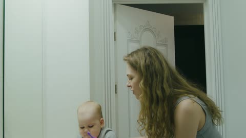 Mother and Child Brushing Their Teeth