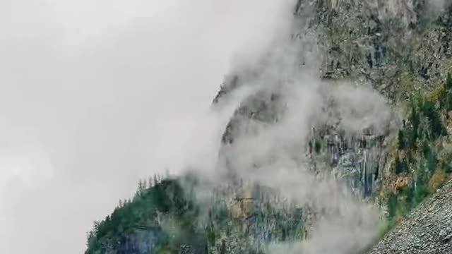 mountain shrouded in clouds and mist