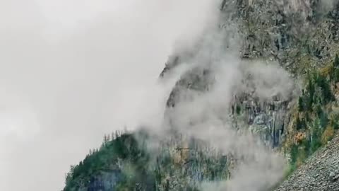 mountain shrouded in clouds and mist